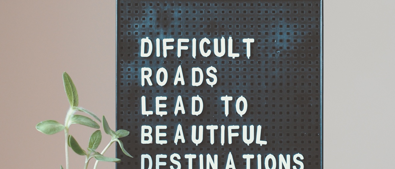 Sign with a quote about difficult roads